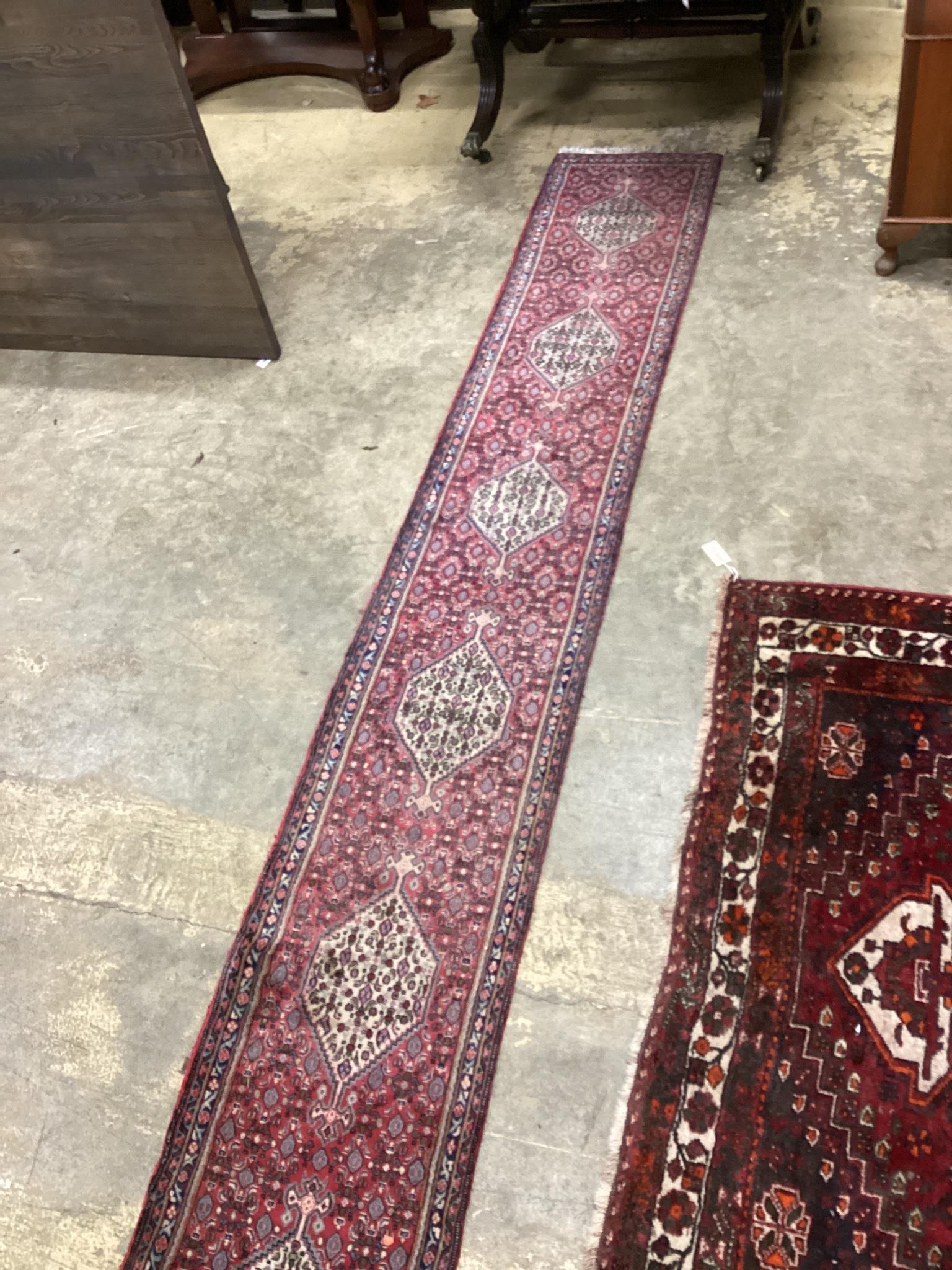 A North West Persian red ground runner, 366 x 55cm